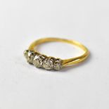 A gold ring set with five graduated claw set diamonds in white gold mounts, marks rubbed, size L,