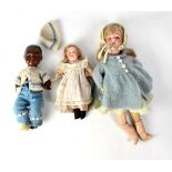 A Heubachkoppelsdorf black baby doll dressed in a blue and white knitted outfit (af),