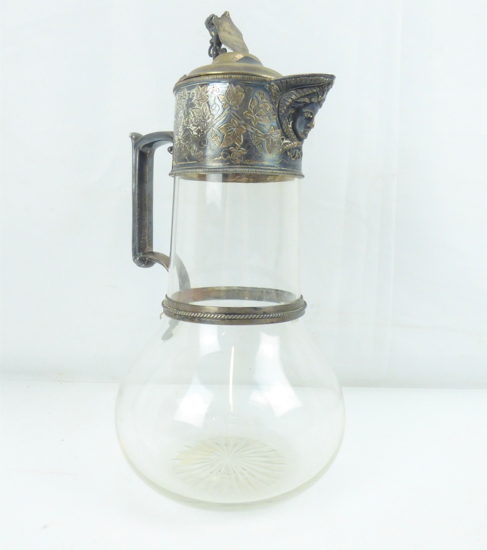 A 19th century claret jug with clear glass body and star cut base, with hallmarked silver lid,