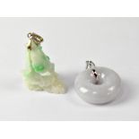 A green jade pendant in the form of a bird on rocky outcrop and a grey jade polo pendant (2).