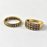 A yellow metal dress ring with three rows of pavé set white stones,