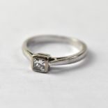 An 18ct white gold ring set with square bezel stone, size L, approx 3g.