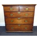 A late 18th early 19th century oak chest of two short over three graduated drawers,