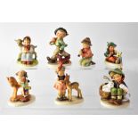 HUMMEL; seven figures of children, to include a boy with umbrella and dog, a little girl with deer,