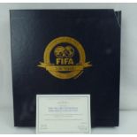 DANBURY MINT; a boxed presentation album for the FIFA 2004 Centennial Philatelic Collection,