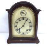An early 20th century mahogany cased dome top mantel clock,