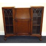 An early 20th century oak bureau bookcase, the small fall front bureau with pigeonhole interior,