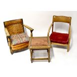 A 1930s oak low open armchair with woven leather back rest,