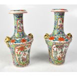 A pair of 19th century Chinese baluster vases with long necks, in the Famille Rose palette,