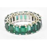 A white metal synthetic emerald full eternity ring, size F, approx 3.6g.