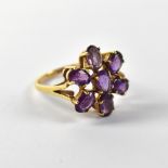 A 9ct gold ladies' dress ring set with floral amethyst cluster of seven oval cut stones,