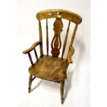 A 19th century elm stick back open armchair with vase-shaped splat,