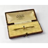 A 15ct gold sapphire and seed pearl bar brooch, length 5.5cm, approx 2.5g, in presentation box.