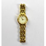 TISSOT; a ladies' gold plated wristwatch, the white enamelled dialed set with raised gold batons,