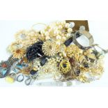 A quantity of costume jewellery to include rings, bracelets, brooches, necklaces, napkin rings,