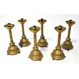 Six 19th century ecclesiastical brass candlesticks with barleytwist stems,