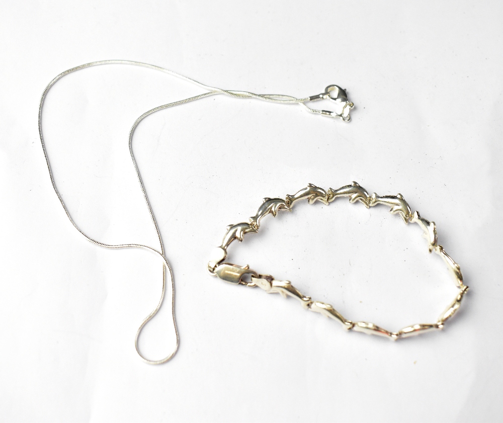 A sterling silver dolphin-form bracelet and a sterling silver necklace (2).