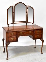 A reproduction burr walnut dressing table with triptych mirror above central drawer with kneehole