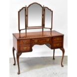 A reproduction burr walnut dressing table with triptych mirror above central drawer with kneehole