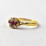 An 18ct gold ring set with diamond and ruby, size O, approx 2g.