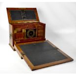 A Victorian oak stationery box with leather bound slope and interior to lid,