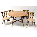 ERCOL; an elm drop-leaf dining table on square splayed legs united by an X-stretcher,