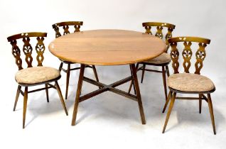 ERCOL; an elm drop-leaf dining table on square splayed legs united by an X-stretcher,