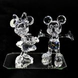 SWAROVSKI; a Disney model of Mickey Mouse together with Minnie Mouse, height 10cm (2).