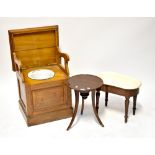 An early 20th century mahogany commode with lift-up top and fold-out arms,