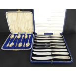 A set of eight Art Deco style dessert knives with filled silver handles and stainless steel blades,