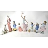 NAO; eight figures to include a lady in elegant Edwardian costume, ballerina (af), seated Pierrot,