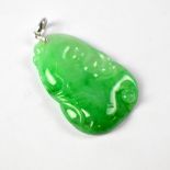 A green jade rectangular pendant with abstract design, length 3cm.