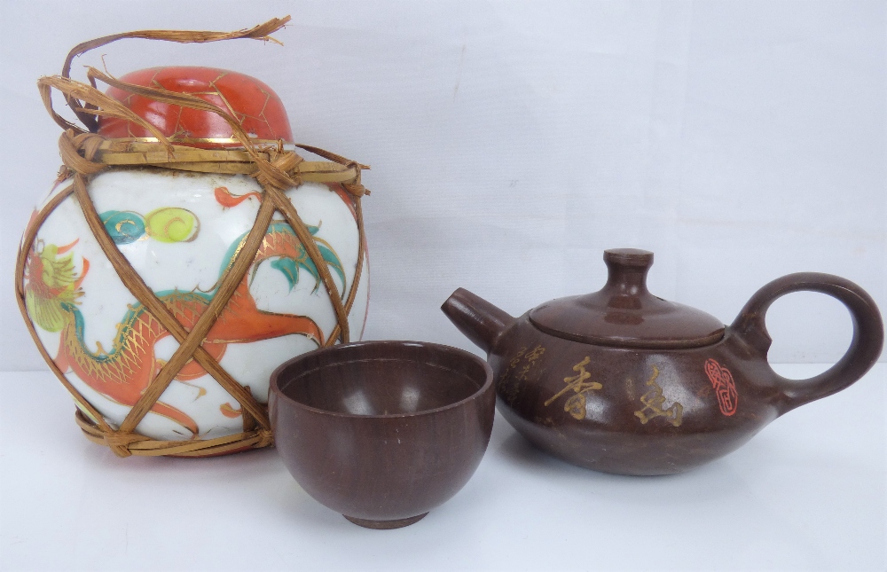 Oriental items to include a small Yixing-style teapot and tea bowl with carved text and script to