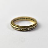 A 9ct gold eternity ring set with white stones, size P, approx 2.7g.