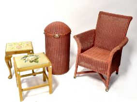 A pink Lloyd Loom style woven armchair,