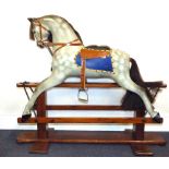 A vintage dapple grey rocking horse with real hair mane and tail, on stile rocker base,