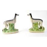 A pair of Staffordshire greyhounds, each on stylised grassy plinth, 29 x 24cm (2).