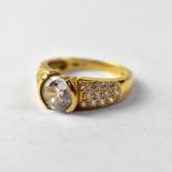 A 14ct (585) gold dress ring with central white stone and white stone cluster shoulders, size N,