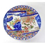 A 19th century Japanese Imari decorated charger with a scroll with two panels,