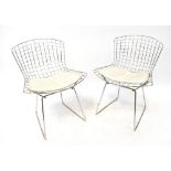 HARRY BERTOIA; a set of eight mid-20th century chrome mesh dining chairs with white vinyl seat pads,
