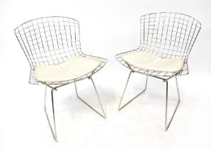 HARRY BERTOIA; a set of eight mid-20th century chrome mesh dining chairs with white vinyl seat pads,