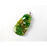 A spinach and multicoloured green jade pendant of abstract form, length 4.5cm.