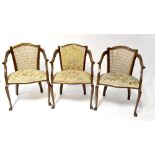 Three matching Edwardian open arm salon chairs, two with bergère backs,