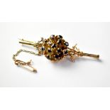 A 9ct gold brooch in the form of a flower head,