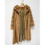 A vintage ladies' blonde mink coat with large shawl wrap collar and open front.