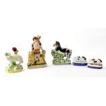 Five Staffordshire figures comprising lion tamer with lions and tiger on shoulder,