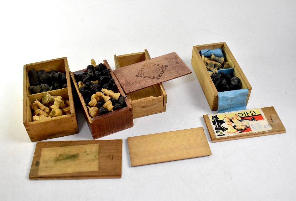 Four vintage wood chess set boxes containing complete and incomplete chess sets (4).