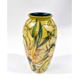 MOORCROFT; a vase decorated with green iris on a yellow green ground, impressed green marks to base,