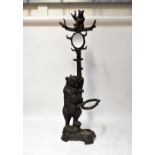 A 19th century Black Forest carved stick stand in the form of a tree with a bear raised on back