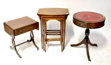 A Georgian-style mahogany leather-topped drum table, an Edwardian-style nest of tables,